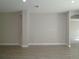 Well-lit living room with neutral walls, wood-look tile flooring, and recessed lighting at 9544 Brave Buck Ave, Land O Lakes, FL 34638