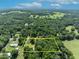 Aerial view of property with defined boundary lines, surrounded by lush trees and tranquil green pastures at 13091 Old Crystal River Rd, Brooksville, FL 34601