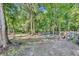 Wooded backyard featuring mature trees and animal enclosures at 13091 Old Crystal River Rd, Brooksville, FL 34601