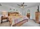 Comfortable bedroom features a ceiling fan, ample natural light, and decorative accents at 13091 Old Crystal River Rd, Brooksville, FL 34601