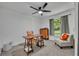 Cozy bedroom featuring natural light, ceiling fan, wooden desk and a neutral color palette at 13091 Old Crystal River Rd, Brooksville, FL 34601