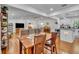 Open-concept layout with hardwood floors seamlessly connects the living room, dining area, and modern kitchen at 13091 Old Crystal River Rd, Brooksville, FL 34601