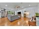 Bright living room with hardwood floors, modern ceiling fan, and large windows at 13091 Old Crystal River Rd, Brooksville, FL 34601