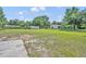 Sprawling property featuring a home, multiple outbuildings, and lush green lawn under a blue sky at 13091 Old Crystal River Rd, Brooksville, FL 34601