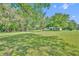 Spacious yard with mature trees and lush green grass provides a serene outdoor space for relaxation and enjoyment at 13091 Old Crystal River Rd, Brooksville, FL 34601