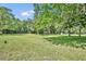 Expansive yard with mature trees and lush green grass offering endless possibilities for outdoor activities at 13091 Old Crystal River Rd, Brooksville, FL 34601