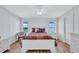 Bright bedroom with a ceiling fan, chair, and wood-look flooring at 9790 66Th N St # 89, Pinellas Park, FL 33782