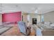 Elegant dining room with a view to living room featuring laminate wood flooring and tray ceiling at 9790 66Th N St # 89, Pinellas Park, FL 33782