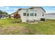 Back view of a home with vinyl siding, energy-efficient windows, and manicured landscaping at 9790 66Th N St # 89, Pinellas Park, FL 33782
