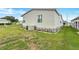 Home featuring vinyl siding, an energy-efficient air conditioner, and lush landscaping at 9790 66Th N St # 89, Pinellas Park, FL 33782