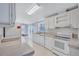 Bright kitchen featuring white cabinetry, ample countertop space, and stainless steel appliances at 9790 66Th N St # 89, Pinellas Park, FL 33782