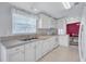 Well-lit kitchen featuring white cabinets, appliances, and tile flooring at 9790 66Th N St # 89, Pinellas Park, FL 33782