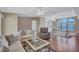 Bright living room with tray ceilings, comfortable seating, and laminate wood flooring at 9790 66Th N St # 89, Pinellas Park, FL 33782