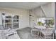 Enclosed patio with sliding glass doors, seating area and view of landscaped yard and patio dining space at 9790 66Th N St # 89, Pinellas Park, FL 33782