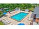 Community pool featuring an abundance of seating and mature trees at 9790 66Th N St # 89, Pinellas Park, FL 33782
