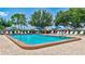 Community pool with ample seating, mature trees, and well maintained landscaping at 9790 66Th N St # 89, Pinellas Park, FL 33782