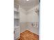 Spacious walk-in closet with shelving, hanging racks, and laminate flooring at 9790 66Th N St # 89, Pinellas Park, FL 33782
