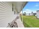 Home featuring a covered walkway, convenient hose hookups, and lush green lawn at 9790 66Th N St # 89, Pinellas Park, FL 33782