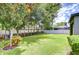 Large backyard featuring lush lawn, mature trees, and manicured landscaping creating a private outdoor retreat at 107 Dakota Hill Dr, Seffner, FL 33584
