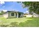 Expansive backyard showcasing well-maintained lawn, covered patio, and privacy fence for relaxed outdoor enjoyment at 107 Dakota Hill Dr, Seffner, FL 33584