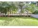 Beautifully maintained backyard featuring lush green grass, trees, and a privacy fence at 107 Dakota Hill Dr, Seffner, FL 33584