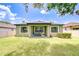 Relaxing backyard with a covered patio, blue chairs, grill and lush lawn at 107 Dakota Hill Dr, Seffner, FL 33584