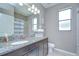 Bathroom featuring granite countertops, dark wood cabinets, a shower-tub combo, and a bright window at 107 Dakota Hill Dr, Seffner, FL 33584