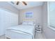 Bedroom featuring a white bed frame, light-colored walls, a ceiling fan, and a bright window at 107 Dakota Hill Dr, Seffner, FL 33584