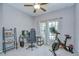 Bedroom featuring a neutral color scheme, a ceiling fan, a computer desk, and an exercise bike at 107 Dakota Hill Dr, Seffner, FL 33584