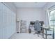 Neutral-colored bedroom featuring a work space, a shelving unit, and a window that brings in natural light at 107 Dakota Hill Dr, Seffner, FL 33584