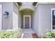 Welcoming front entrance with an arched entryway and stylish exterior lighting at 107 Dakota Hill Dr, Seffner, FL 33584