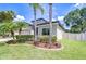Manicured lawn with palm trees and decorative landscaping enhances curb appeal at 107 Dakota Hill Dr, Seffner, FL 33584
