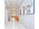 Hallway with a tray ceiling, artwork, and a view into the living room at 107 Dakota Hill Dr, Seffner, FL 33584