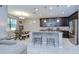 Bright kitchen and dining area with granite island, stainless appliances, dark wood cabinets, and seating at 107 Dakota Hill Dr, Seffner, FL 33584