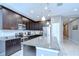 Well-appointed kitchen showcasing dark cabinetry, granite counters, and stainless steel appliances with tile flooring at 107 Dakota Hill Dr, Seffner, FL 33584