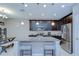Open kitchen with granite countertops, dark cabinetry, stainless appliances, and a central island with seating at 107 Dakota Hill Dr, Seffner, FL 33584