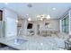 Modern kitchen with granite countertops and stainless appliances, blending into the open living area at 107 Dakota Hill Dr, Seffner, FL 33584