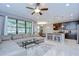 Open concept living room flows into a kitchen with an island, bar stools, and stainless steel appliances at 107 Dakota Hill Dr, Seffner, FL 33584