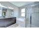 Main bathroom showing double vanity, soaking tub, glass enclosed shower and neutral color palette at 107 Dakota Hill Dr, Seffner, FL 33584
