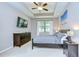 The main bedroom features a tray ceiling, dark wood furnishings, and a large window overlooking the backyard at 107 Dakota Hill Dr, Seffner, FL 33584
