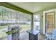 Back patio showcasing a barbecue grill, chairs, and a view of the green backyard at 107 Dakota Hill Dr, Seffner, FL 33584