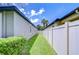 Clean side yard with well-maintained lawn and a tall privacy fence offering secluded outdoor space at 107 Dakota Hill Dr, Seffner, FL 33584