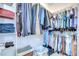 Organized walk-in closet featuring shelving with folded towels and clothes hanging on rods, maximizing storage at 107 Dakota Hill Dr, Seffner, FL 33584