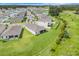 Beautiful aerial view of the homes' location, near a lake, and adjacent to a green space at 13797 Wineberry Dr, Dade City, FL 33525