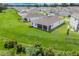 Aerial view of the home showcasing the well-maintained lawn and screened in porch at 13797 Wineberry Dr, Dade City, FL 33525