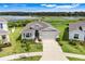 Beautiful home showcasing a well-kept lawn, in a tranquil community near a scenic lake at 13797 Wineberry Dr, Dade City, FL 33525