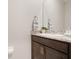 Well-lit powder room features a granite countertop and decorative mirror at 13797 Wineberry Dr, Dade City, FL 33525