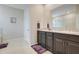 Bright bathroom with dual sinks, granite countertops, walk-in shower and modern fixtures at 13797 Wineberry Dr, Dade City, FL 33525