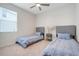 Comfortable bedroom features two twin beds and neutral decor at 13797 Wineberry Dr, Dade City, FL 33525