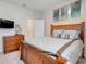 Comfortable bedroom features a wood-framed bed with light blue bedding and a TV at 13797 Wineberry Dr, Dade City, FL 33525